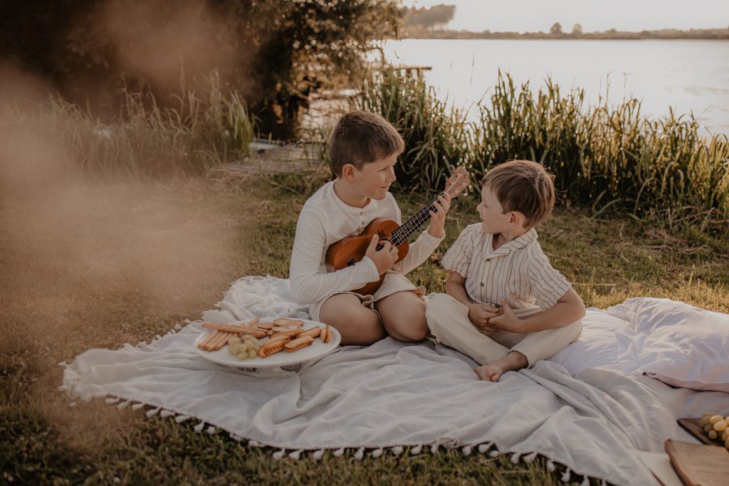 Séance photo en extérieur, frères qui s'amusent pendant un pique-nique