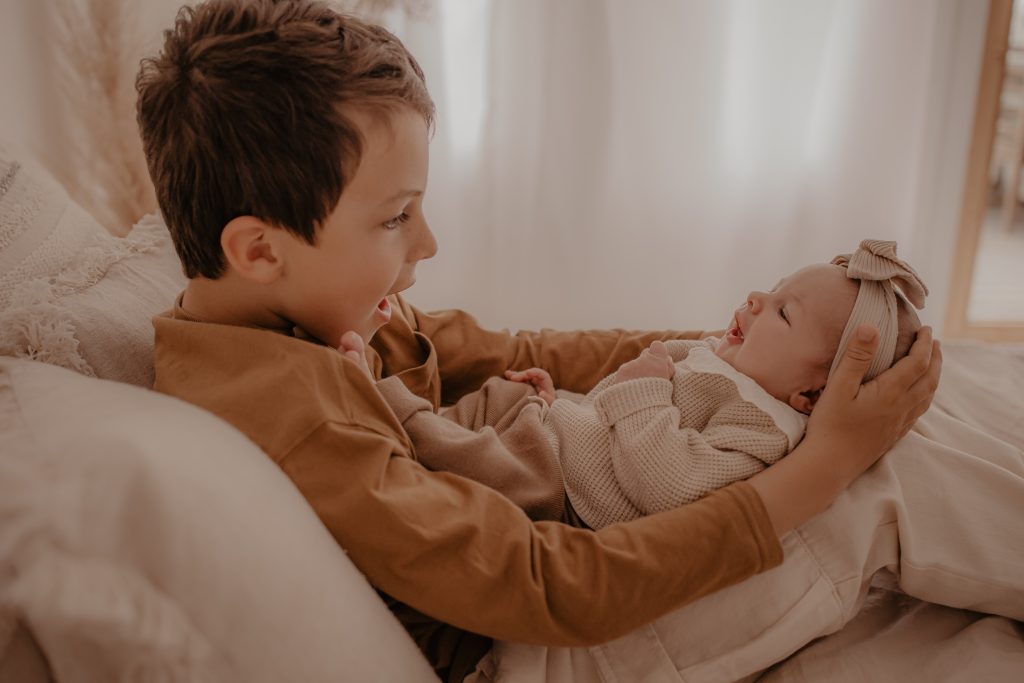 Moment d'amour entre grand frère et bébé